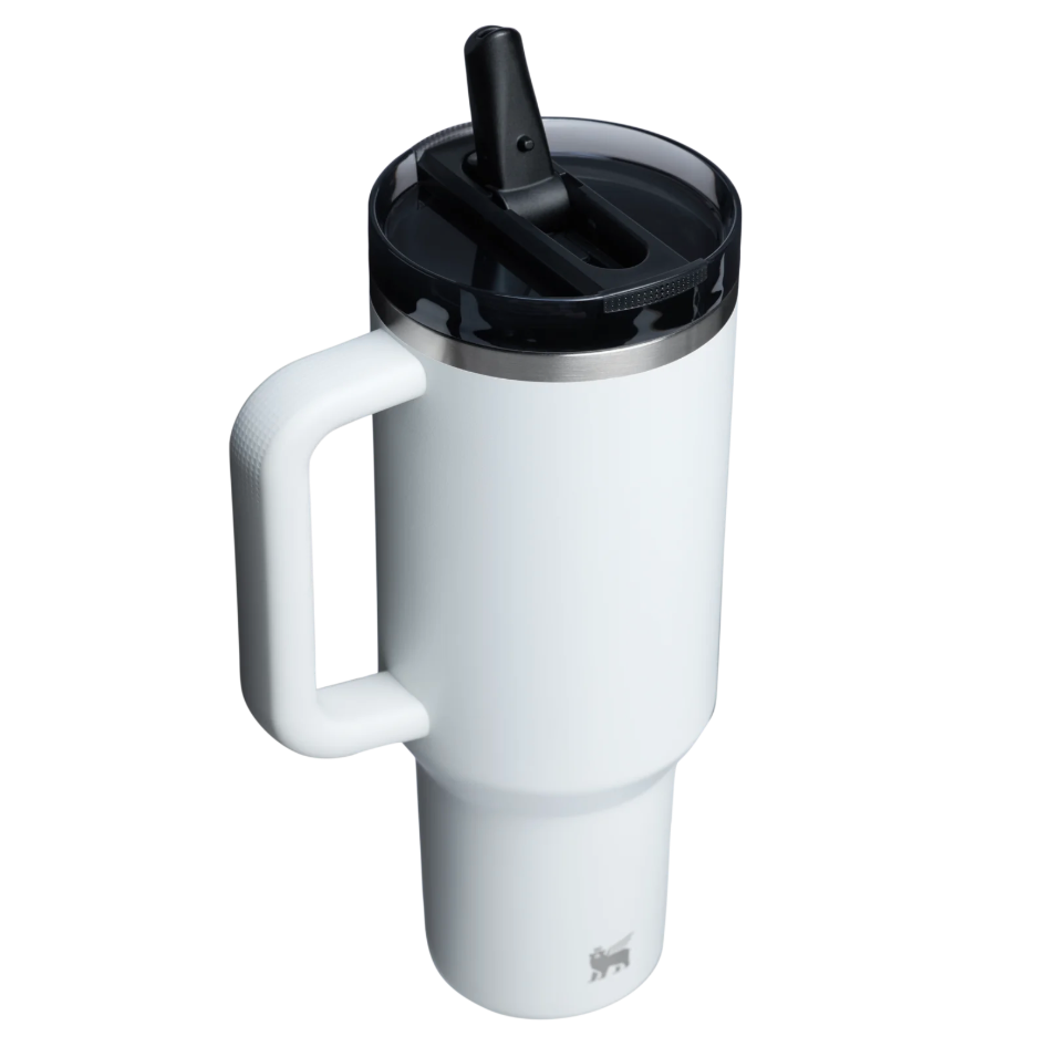 White travel mug with a black lid on a white background